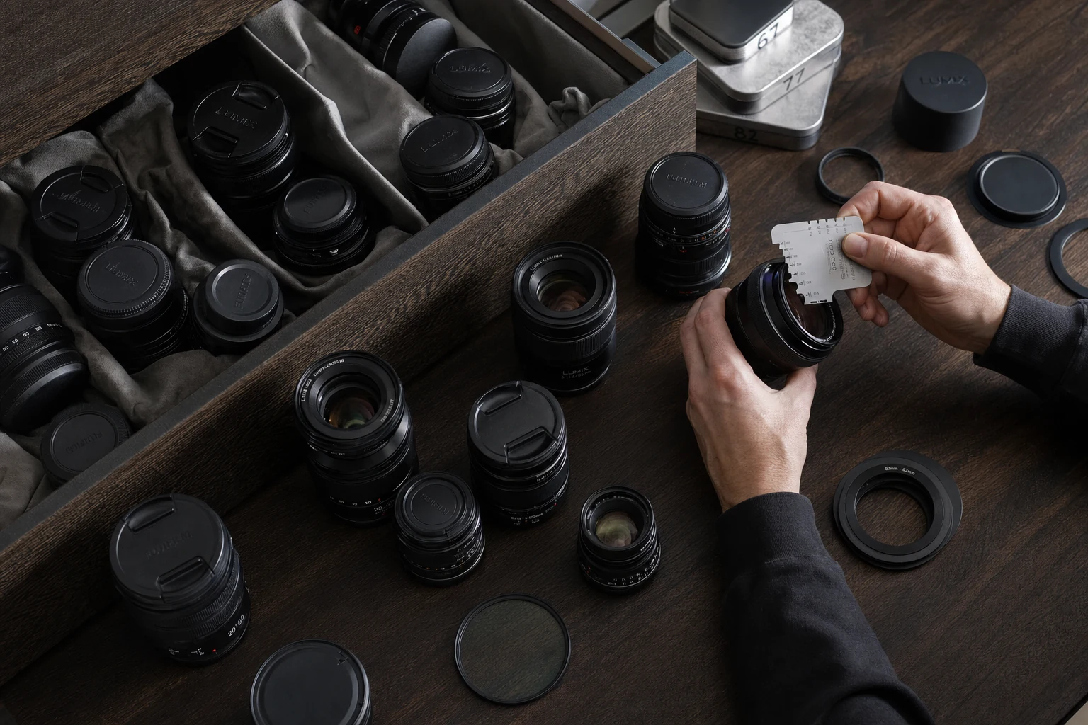 Organized Fujifilm and Lumix lens collection with visible mount caps and filter cases